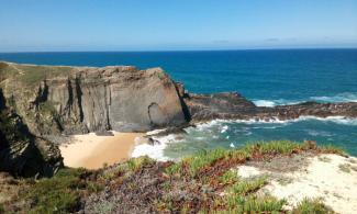 Beach with cliffs.